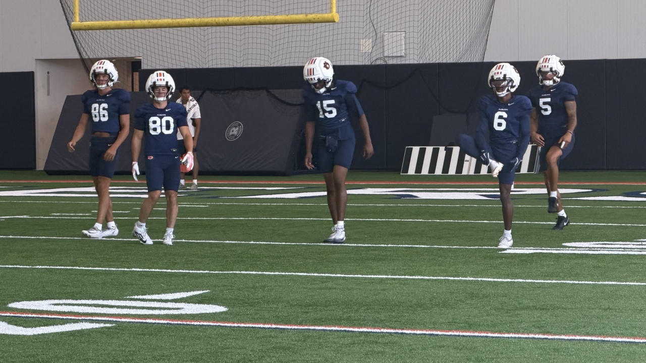 Auburn receivers working through a preseason practice inside the football facility