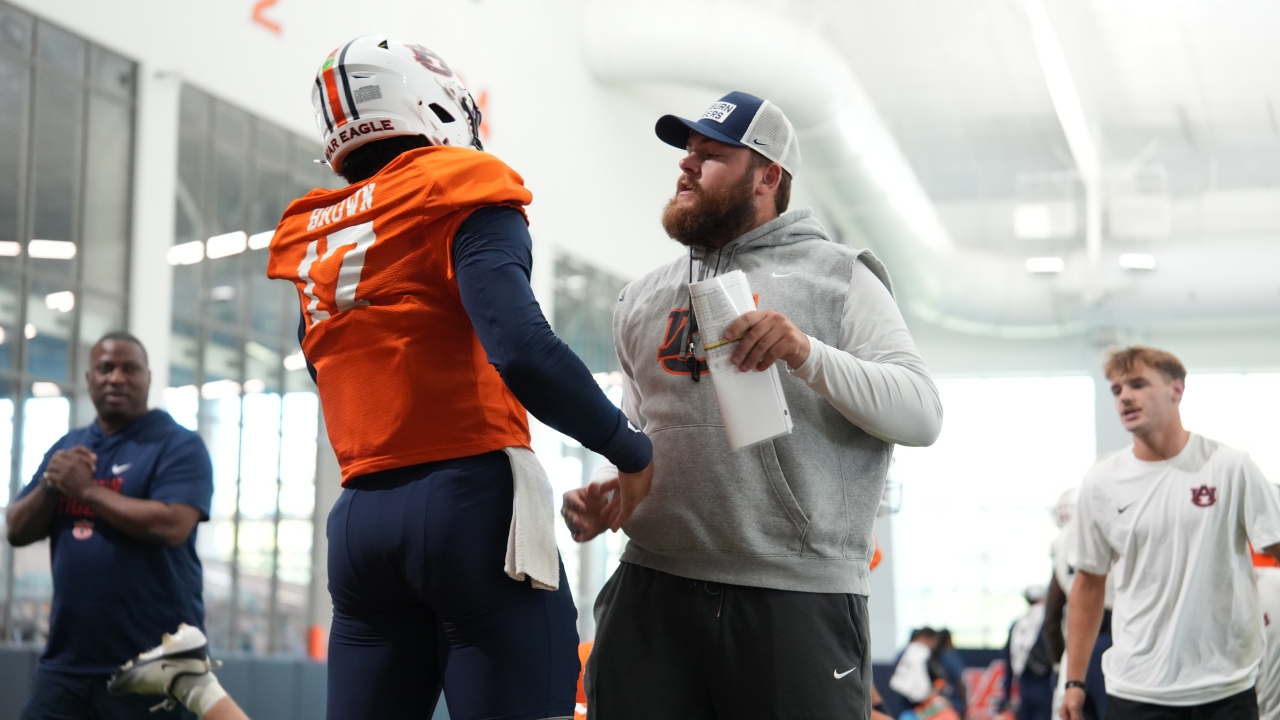 Auburn quarterback and coach talking during preseason practice